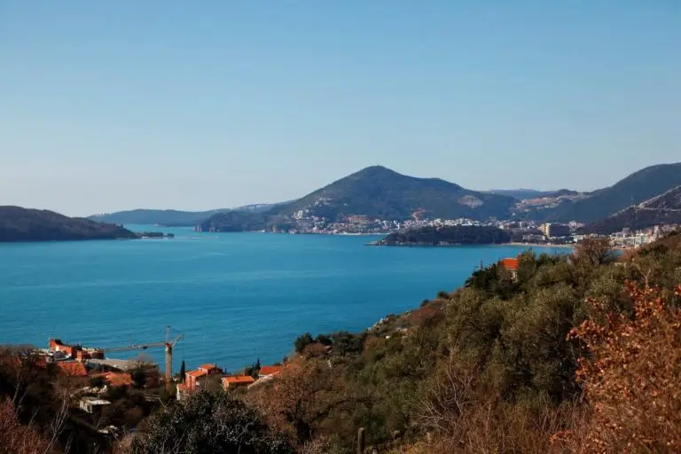 Coastal bay with mountains, town, and hillside houses