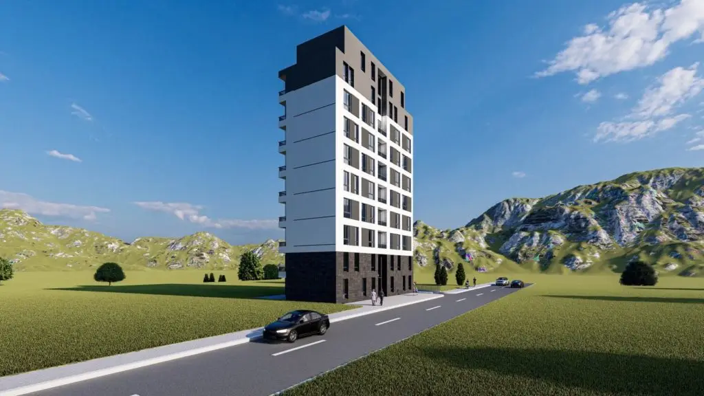 Tall modern apartment building beside a road in grassy mountains