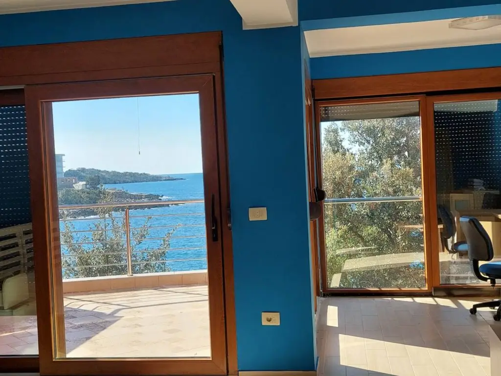Blue room with balcony doors overlooking the sea