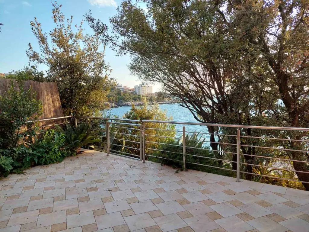 Tiled terrace with metal railing overlooking the sea