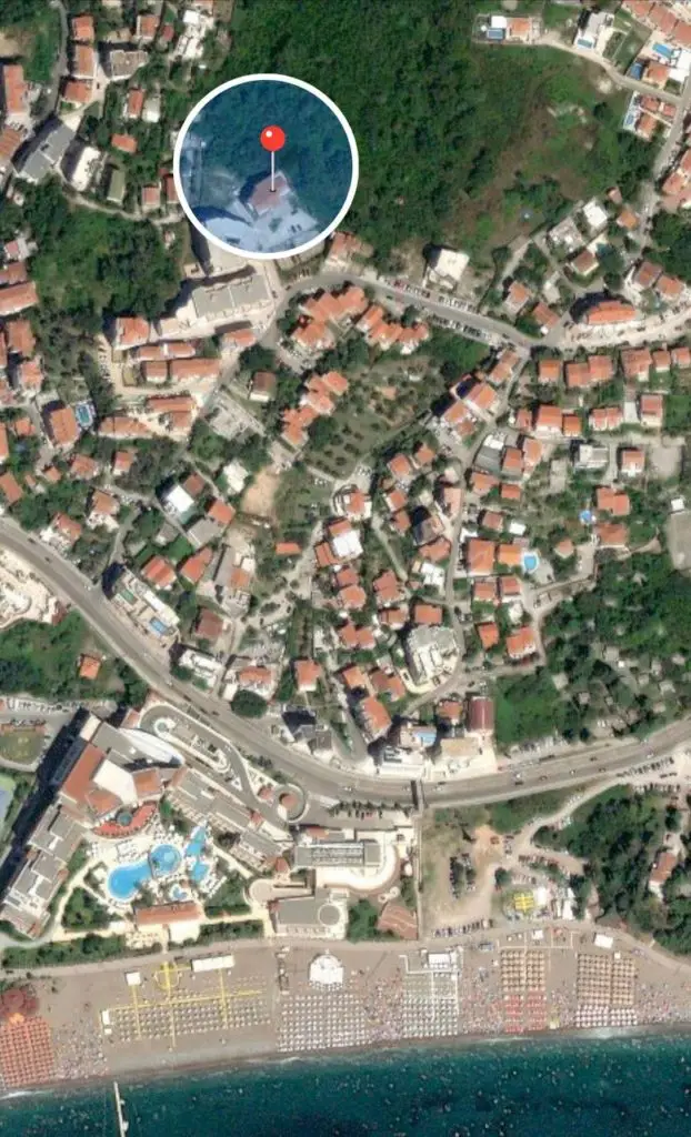 Satellite map with red location pin near the coast