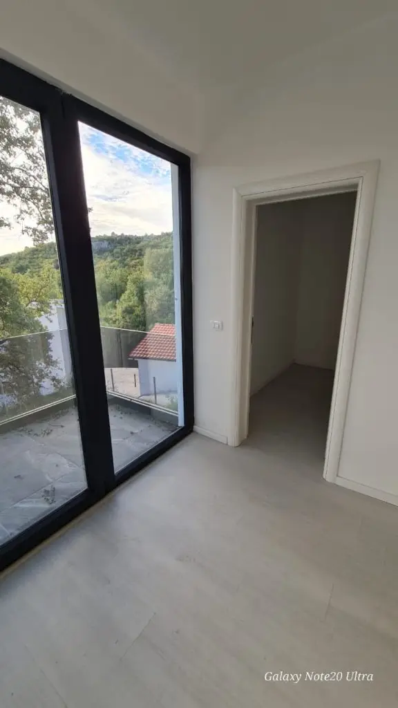 Empty room with black-framed window,