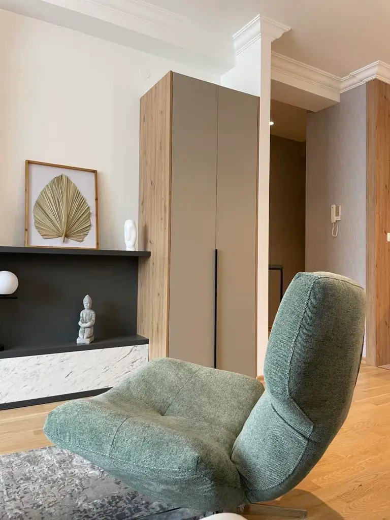 Green lounge chair in modern living room with cabinet