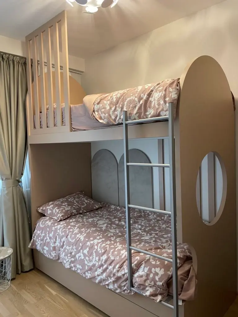 Beige bunk bed with floral bedding and ladder