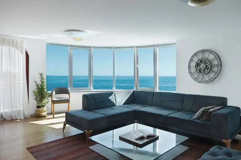 Living room with blue sectional sofa and ocean view