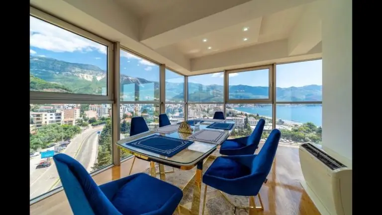 Dining room with blue chairs and panoramic mountain sea view