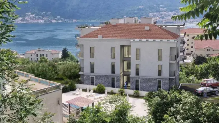 Seaside apartment building with red roof and courtyard