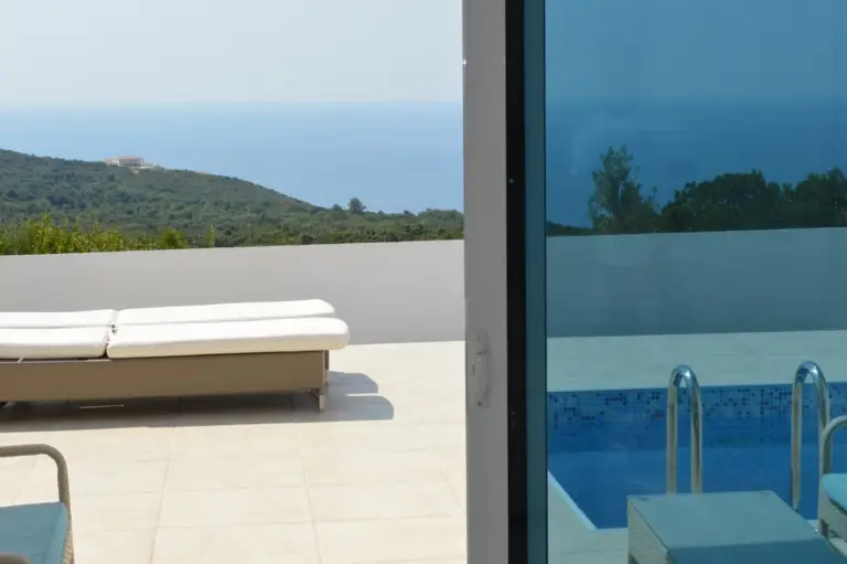 Terrace sun lounger overlooking sea and hills, beside pool