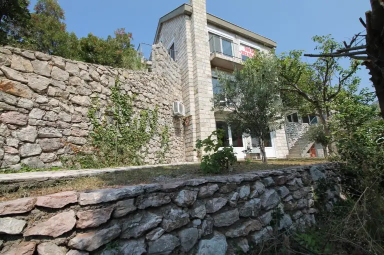 Stone house with terraces and surrounding stone walls