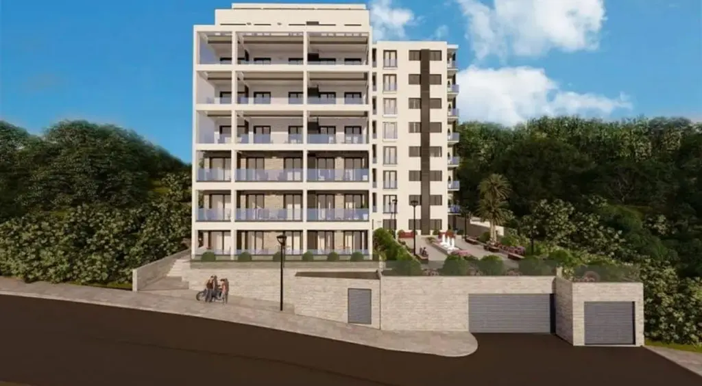 Rendering of a modern apartment building with terraces and a landscaped courtyard