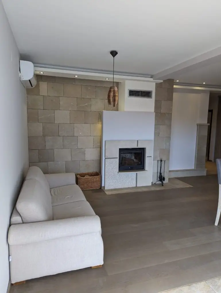 Modern living room with beige sofa and fireplace