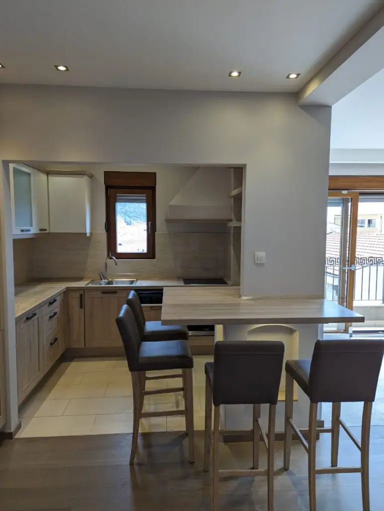 Modern kitchen with breakfast bar and three stools