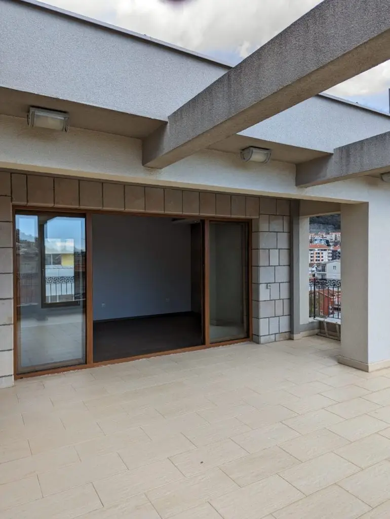 Rooftop terrace with sliding glass doors and city view