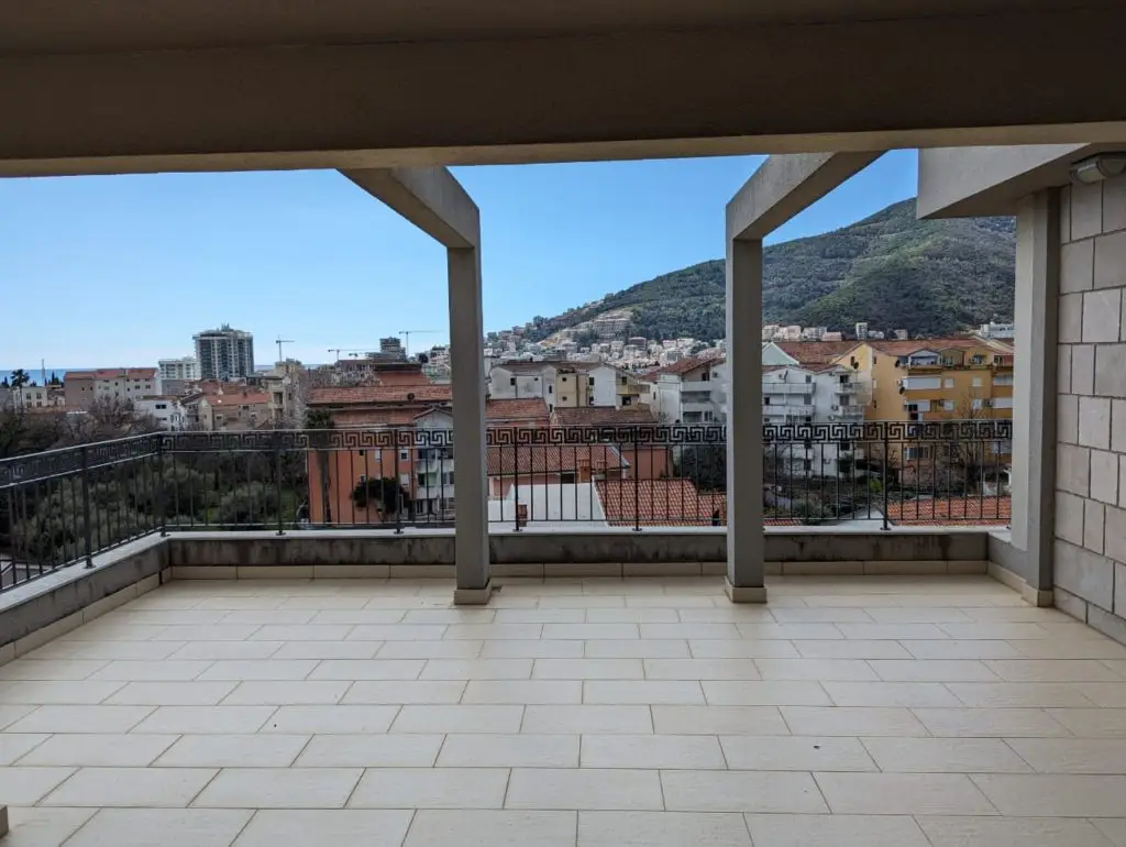 Spacious tiled balcony with city and mountain view