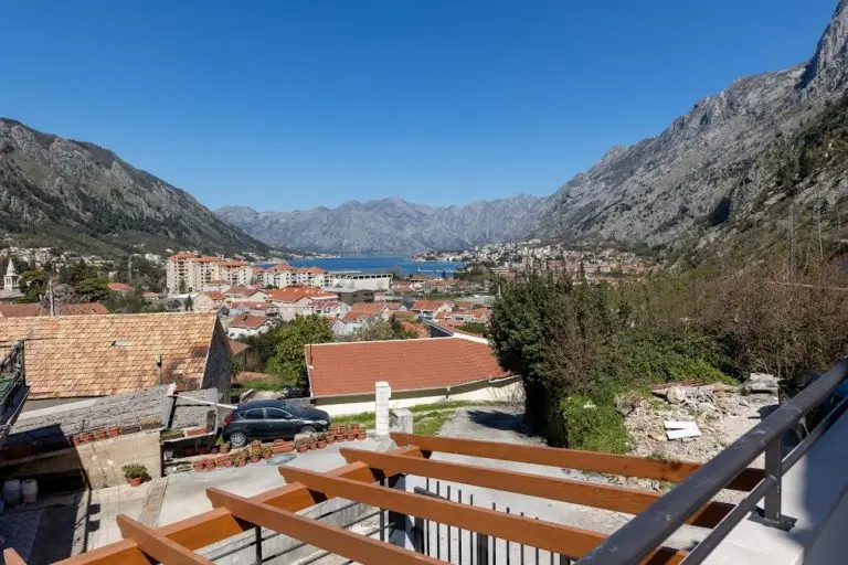 Mountain bay view over red-roofed town and terrace