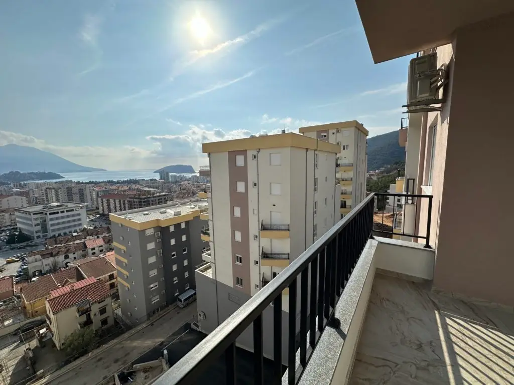 Balcony view over city buildings and the sea