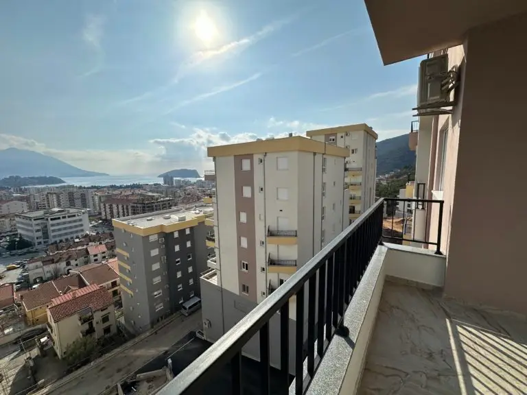 Balcony view over city buildings and the sea