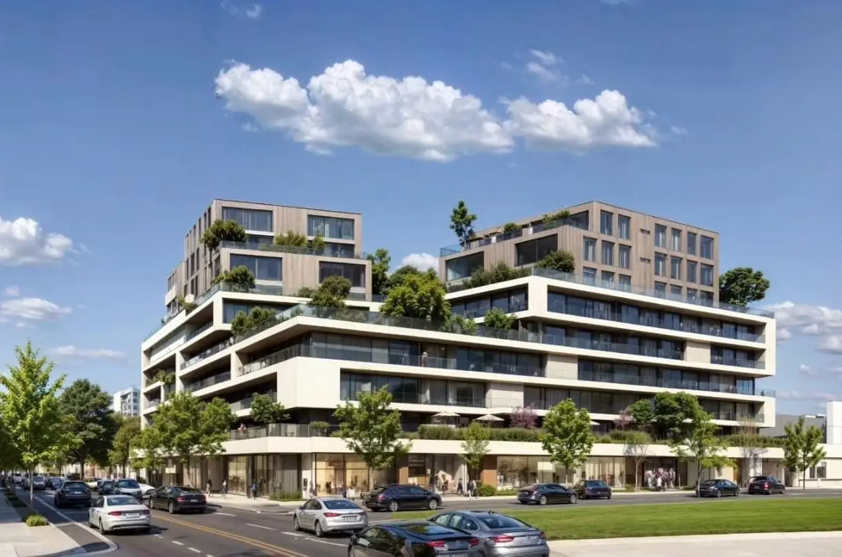 Modern terraced apartment building with trees and parked cars