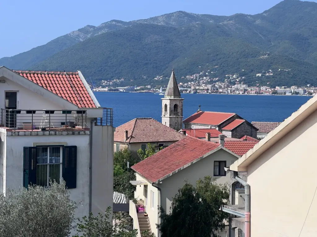 Red-roofed houses and church tower overlooking the bay