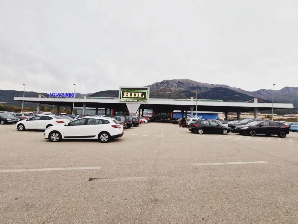 Exterior of HDL shopping center parking lot with cars and LC Waikiki sign
