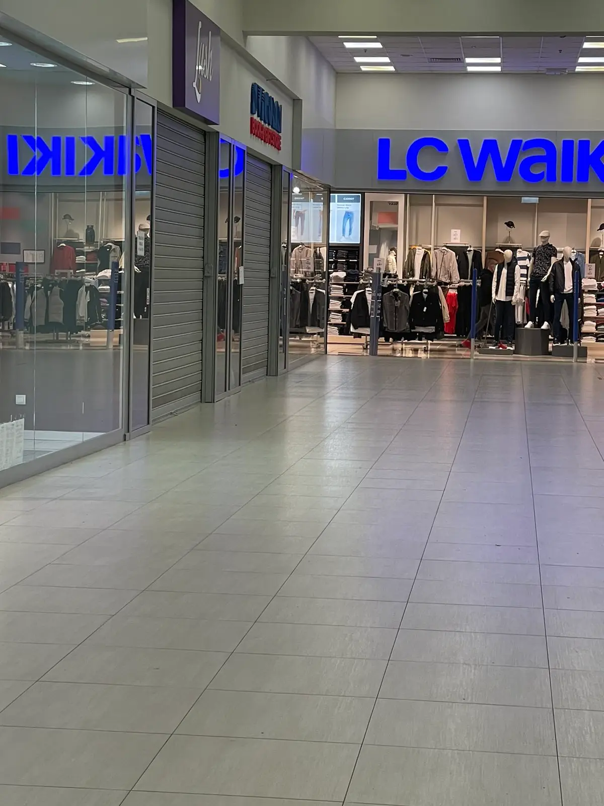 Shopping mall corridor with LC Waikiki clothing store and closed storefronts