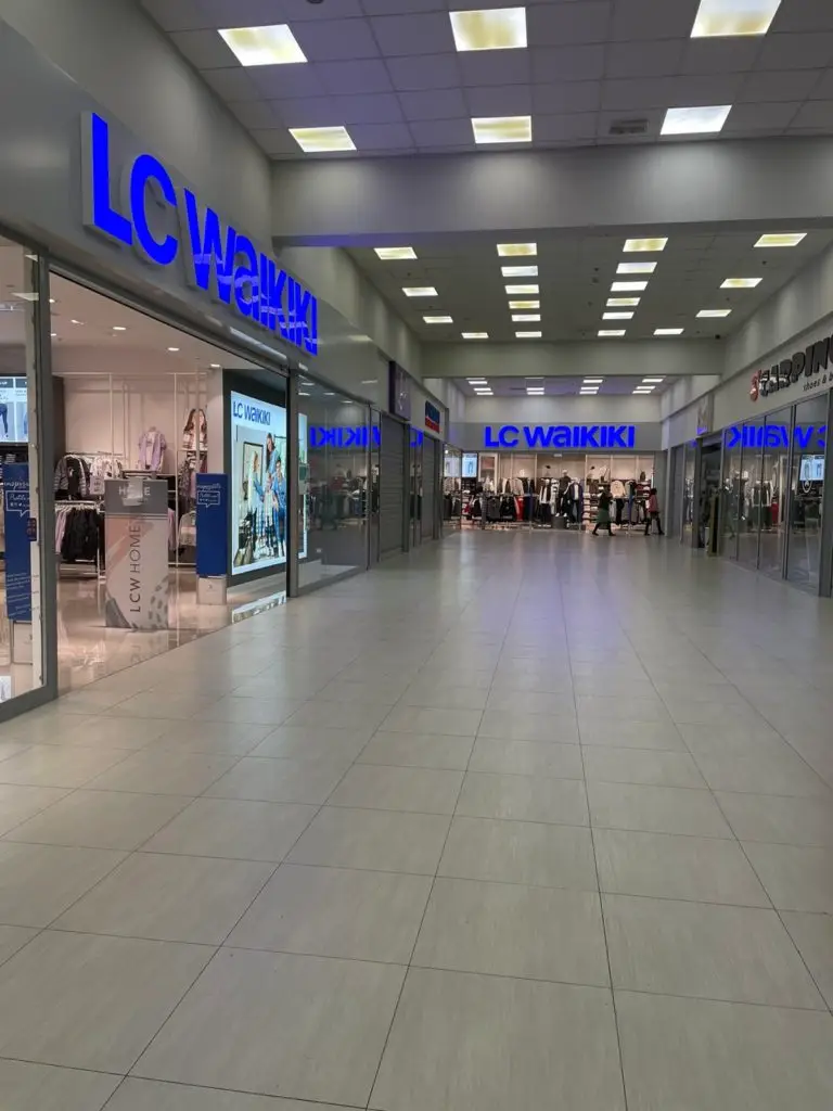 Shopping mall corridor with LC Waikiki store fronts and blue signs