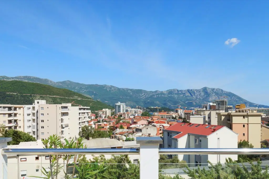 Rooftop terrace railing overlooking Budva city and mountains