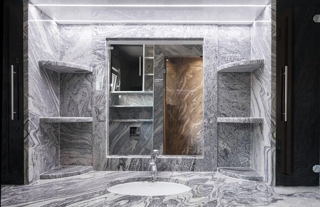 Marble bathroom vanity with mirror, sink, and built-in shelves