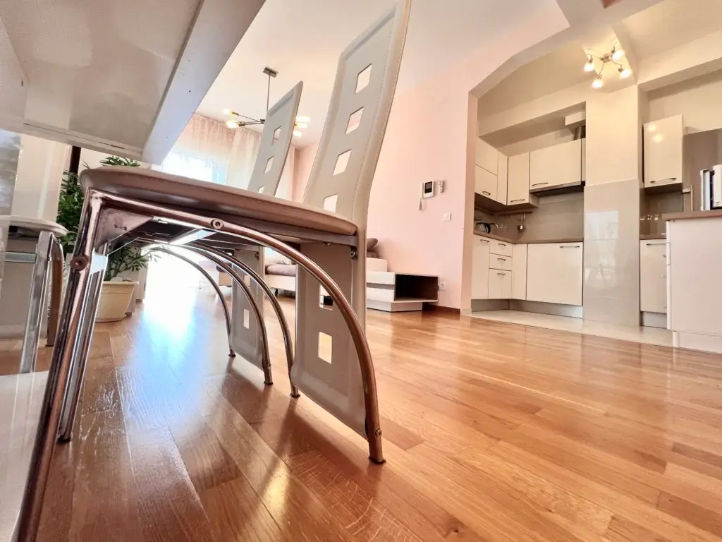 Low-angle view of modern dining chairs and kitchen interior