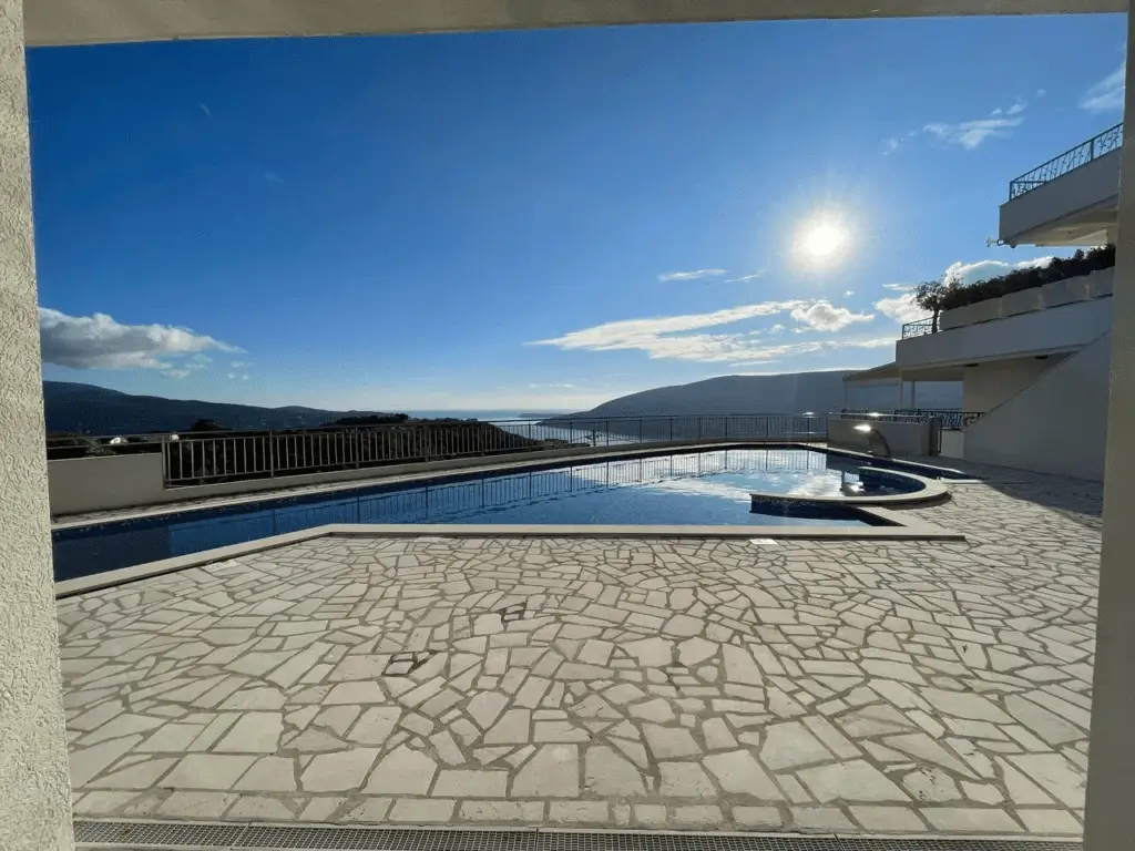 Outdoor pool terrace with sea and mountain view