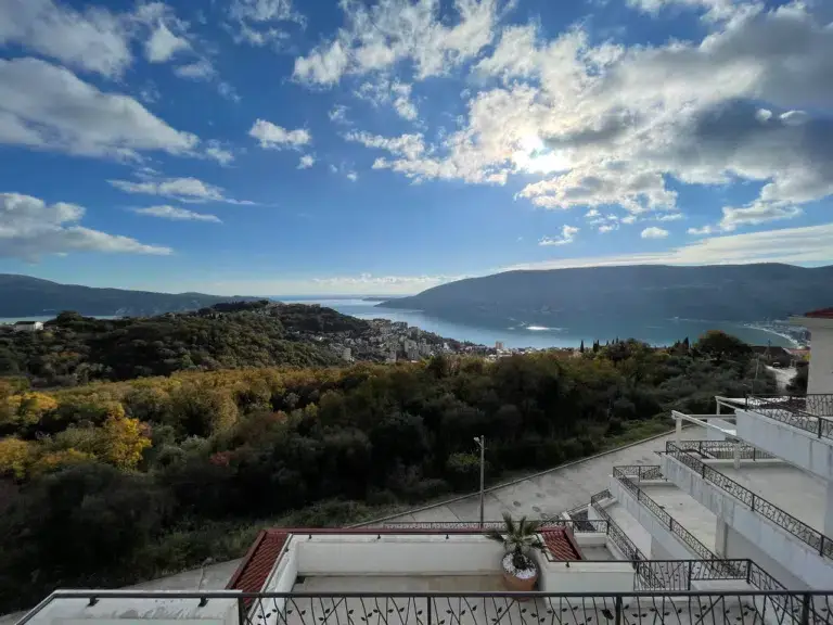 Bay view over hills from white balcony terrace