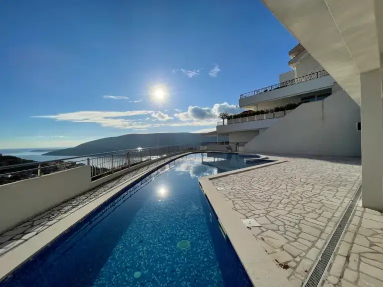 Outdoor swimming pool terrace with sea and mountain view