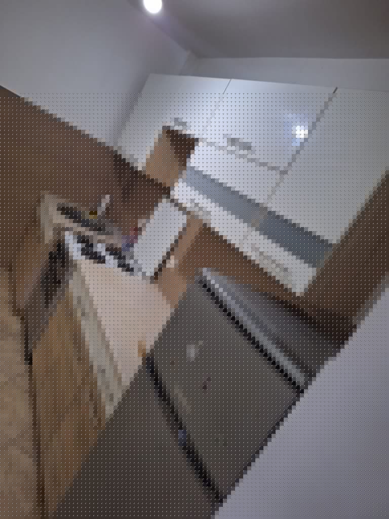 Small kitchen with white cabinets, stove, sink, and refrigerator
