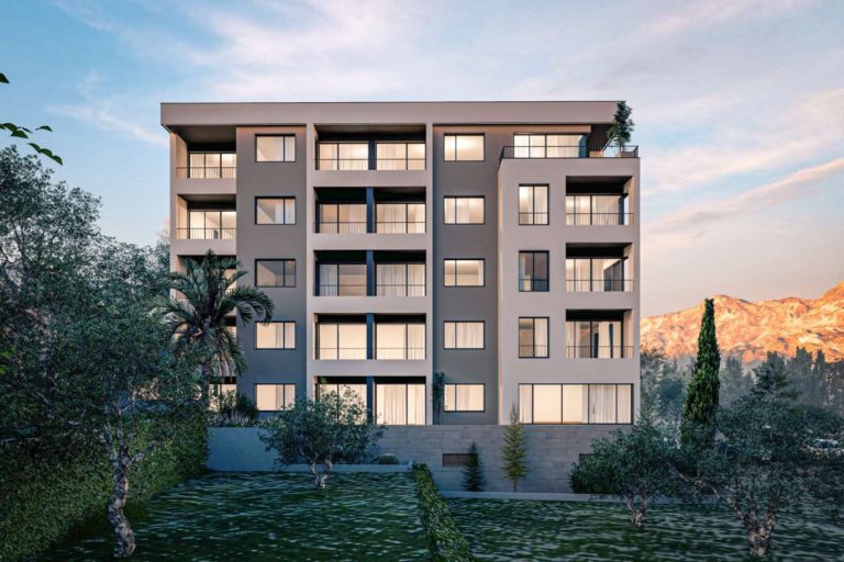 Partially visible modern apartment building under pastel sky