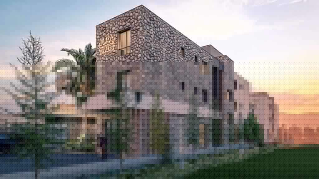 Rendering of a modern stone-faced multi-story building at sunset