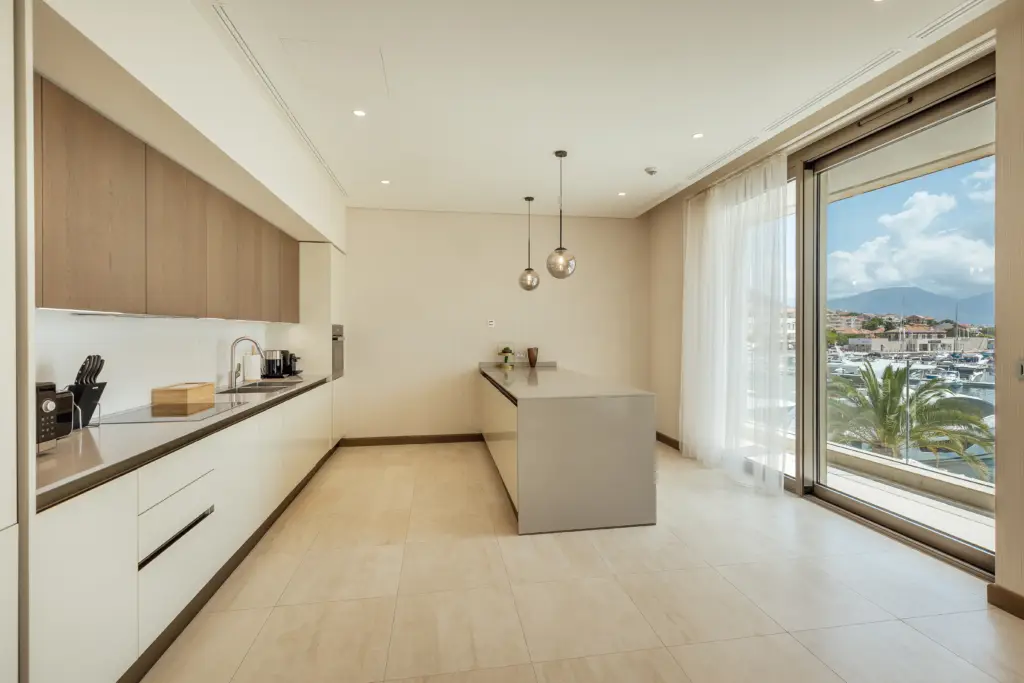 Modern kitchen with island and marina view through sliding glass door