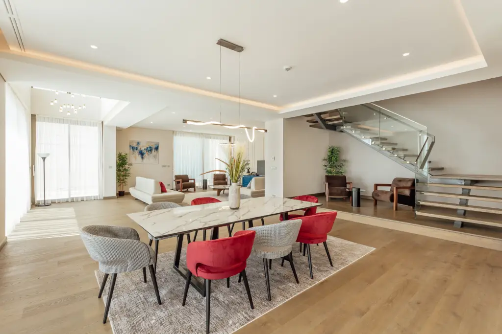 Modern open-plan dining room with staircase and lounge area