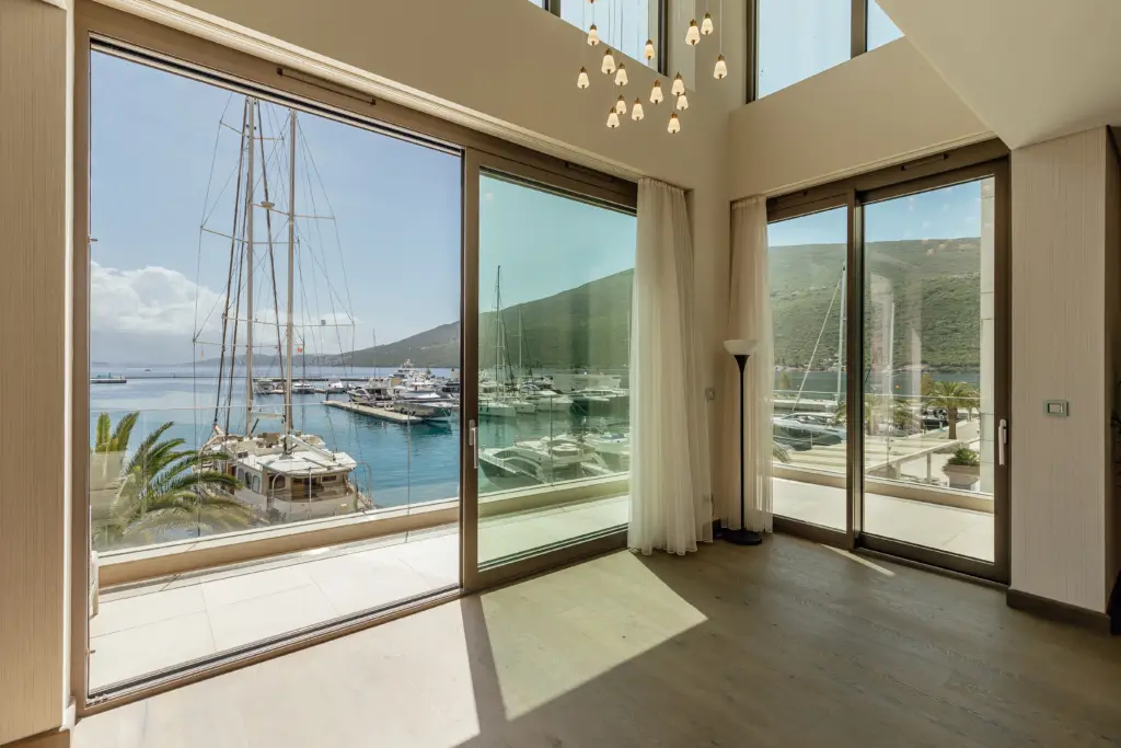 Luxury apartment interior with floor-to-ceiling marina views