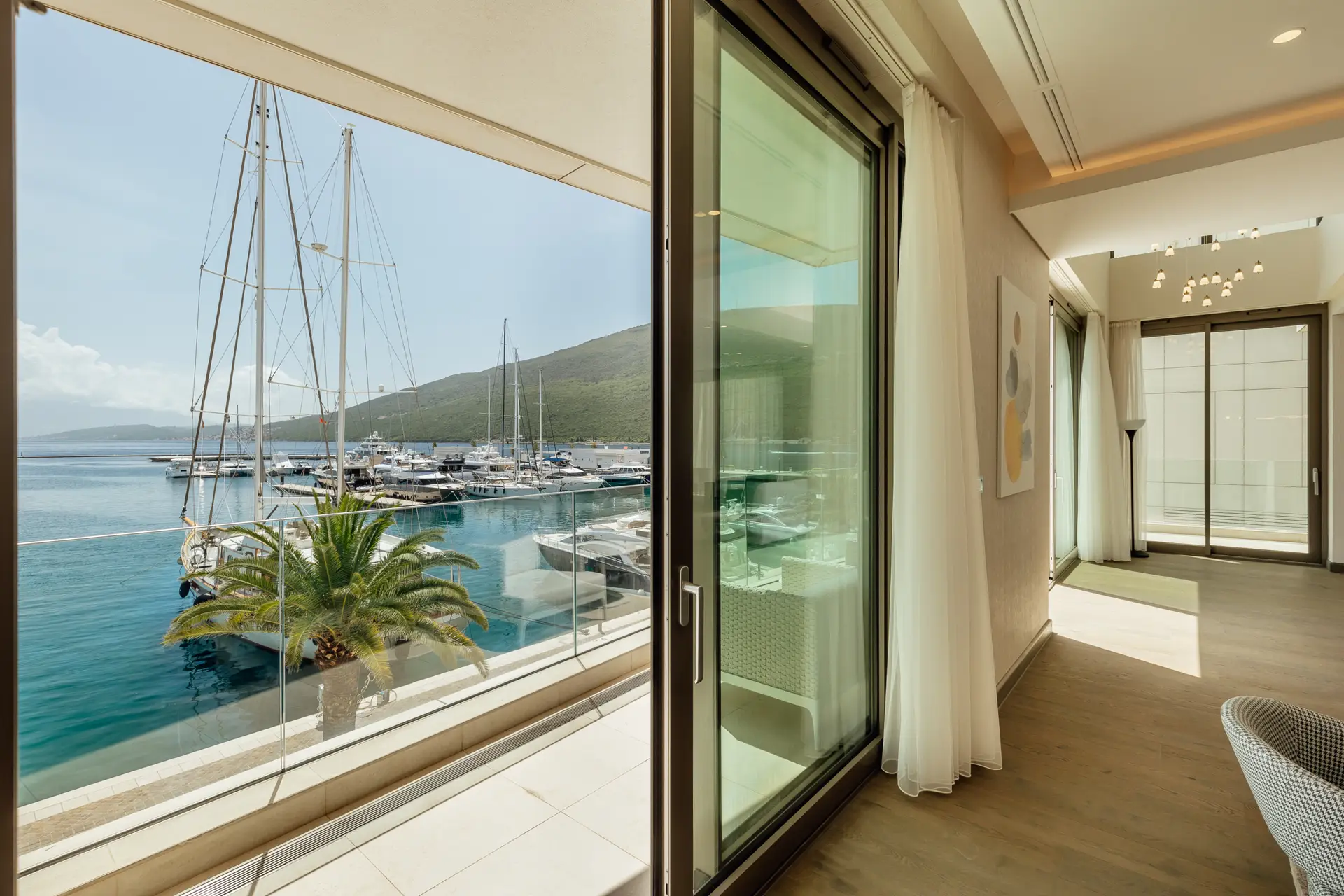 Luxury apartment interior overlooking marina and sailboats