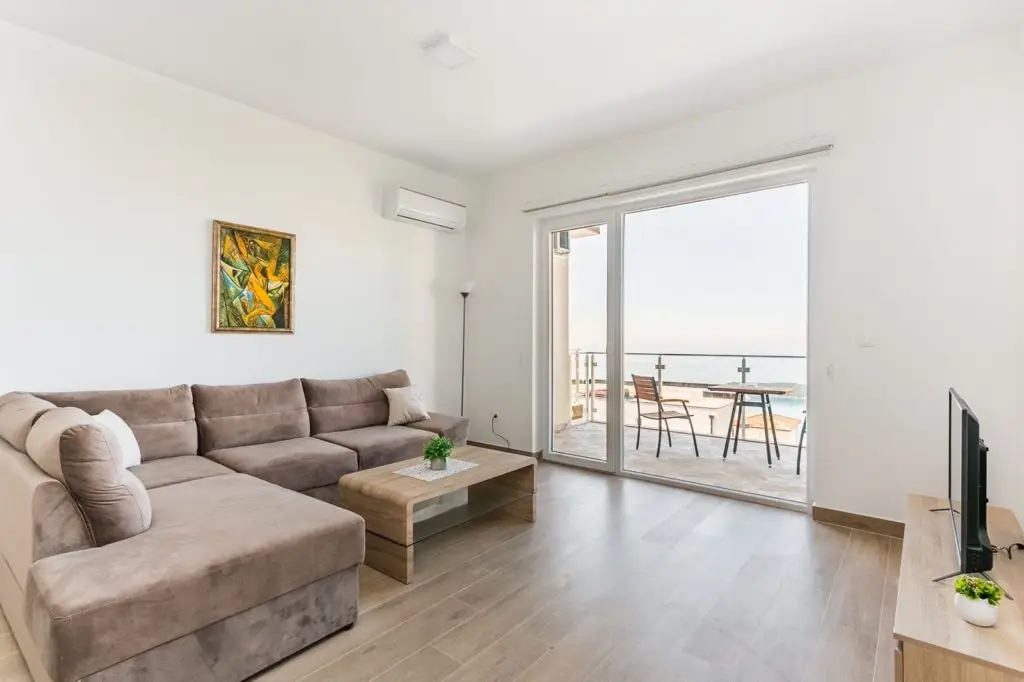 Living room with sectional sofa and sea-view balcony