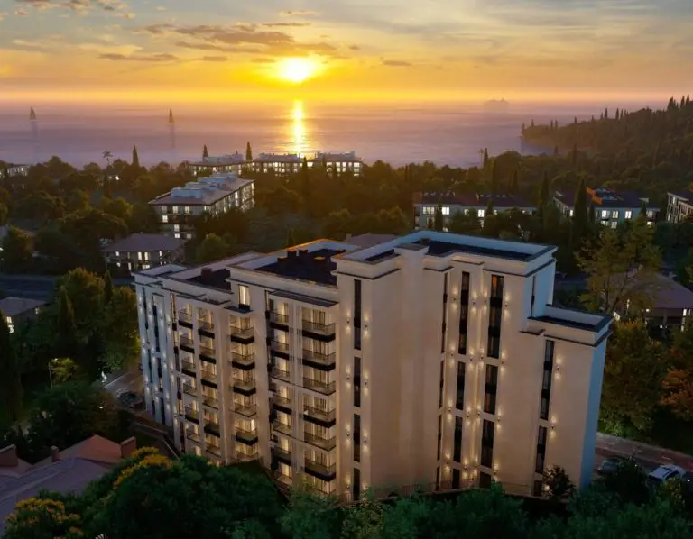 Modern apartment building at sunset above the sea