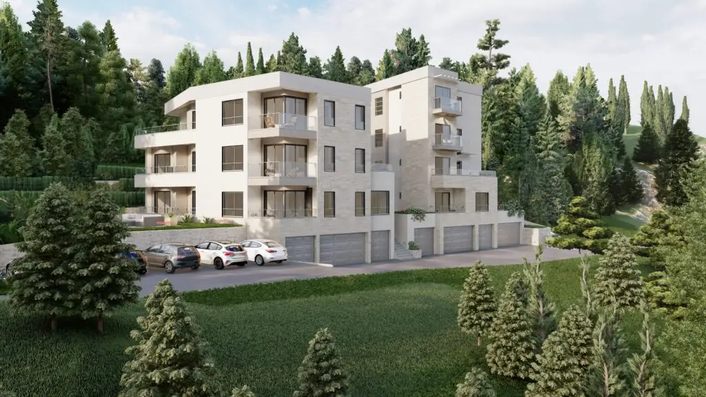 Modern white apartment building with balconies and garages, surrounded by trees