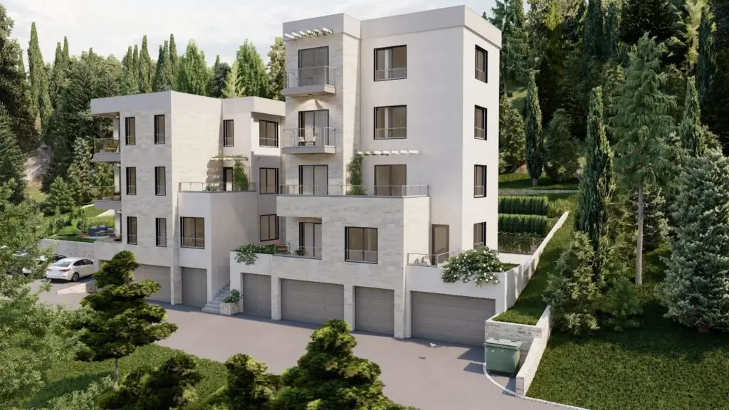 Modern apartment building with balconies and garage doors, surrounded by trees