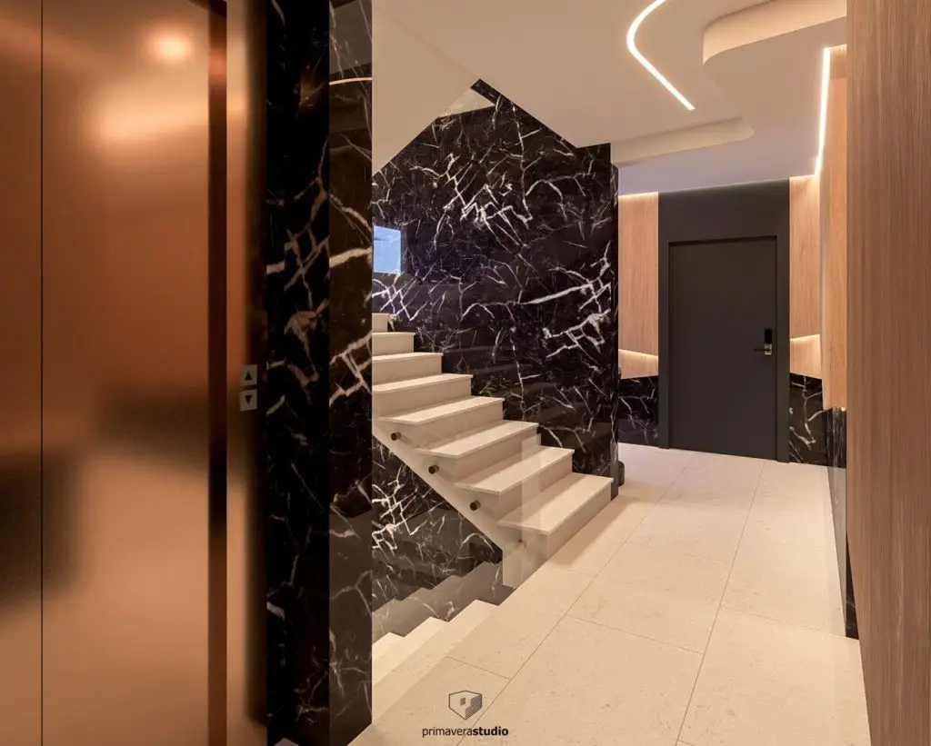 Modern stairwell with black marble walls and white stairs