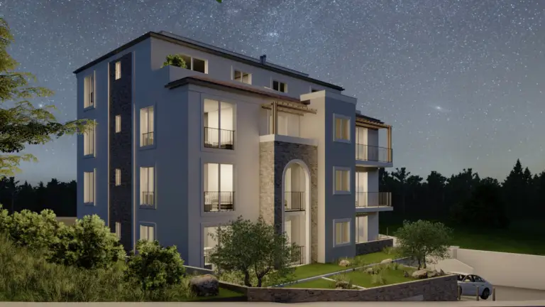 Modern apartment building at night with lit windows and balconies