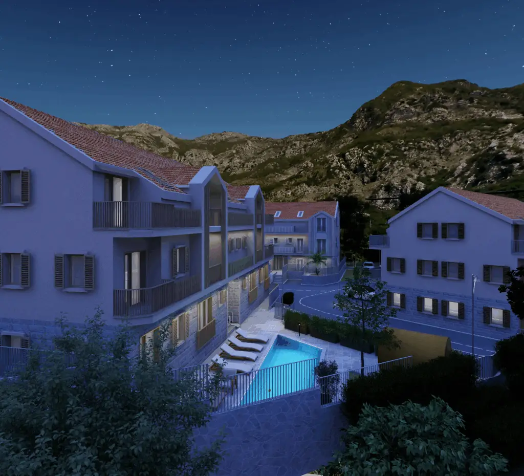 Nighttime rendering of apartment buildings with a lit pool and mountains