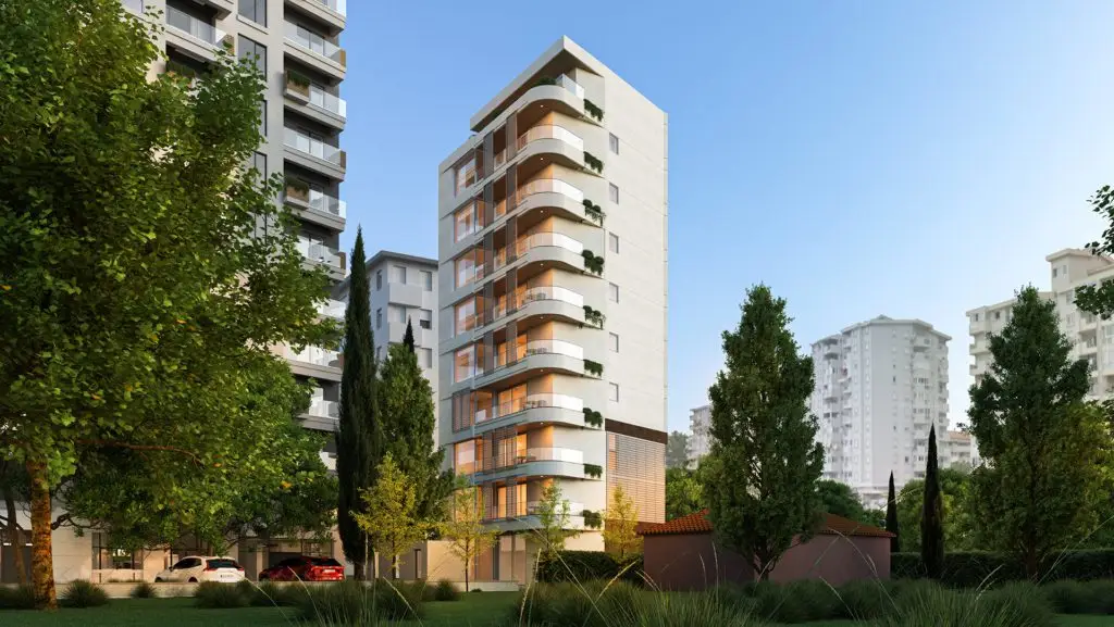 Modern apartment building with curved balconies and trees in front