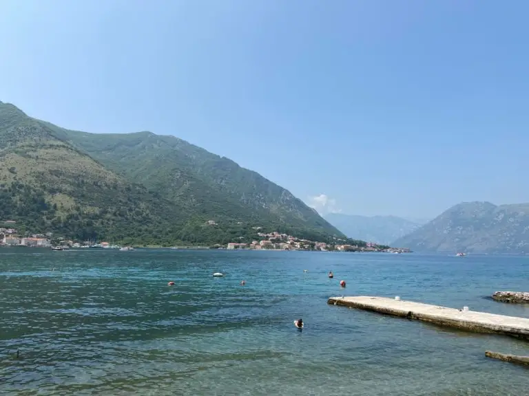 Mountain bay with calm water and a concrete pier