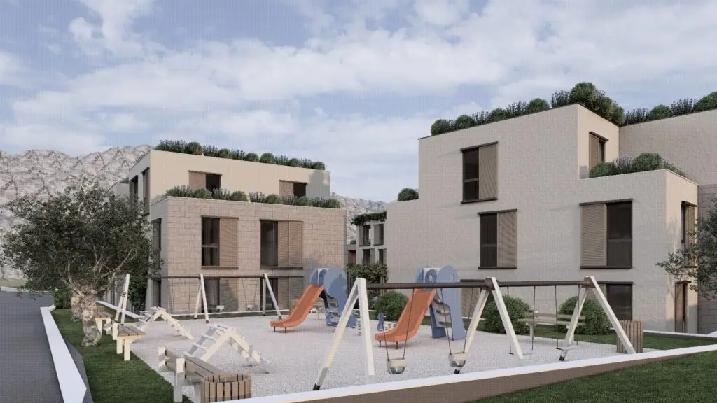 Children’s playground with swings and slides beside apartment buildings