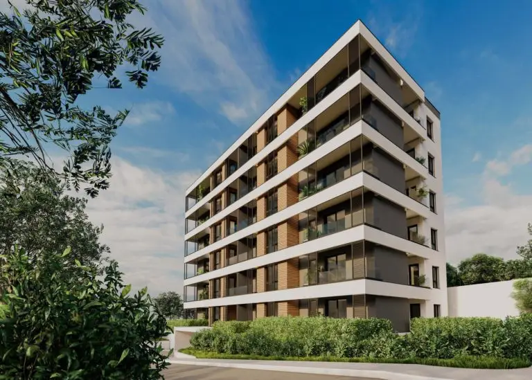 Modern apartment building with balconies and greenery